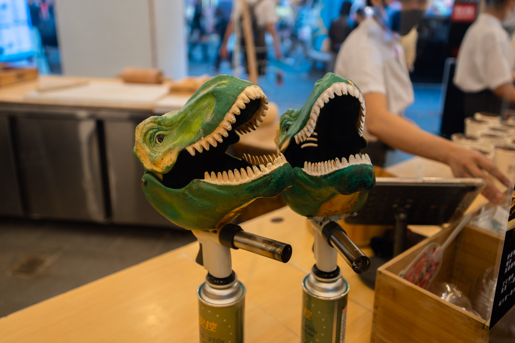 Dinosaur-shaped torches at Xing Fu Tang